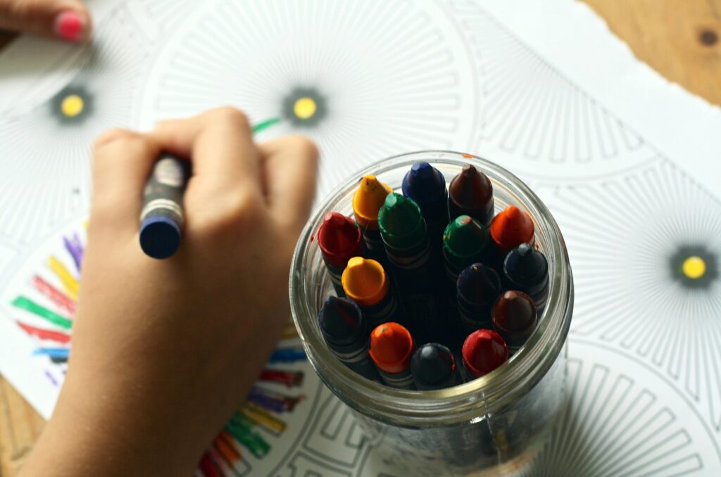 crayons-coloring-book-coloring-book-159579-159579 A child drawing with colorful crayons, fostering creativity and fun in a learning environment.